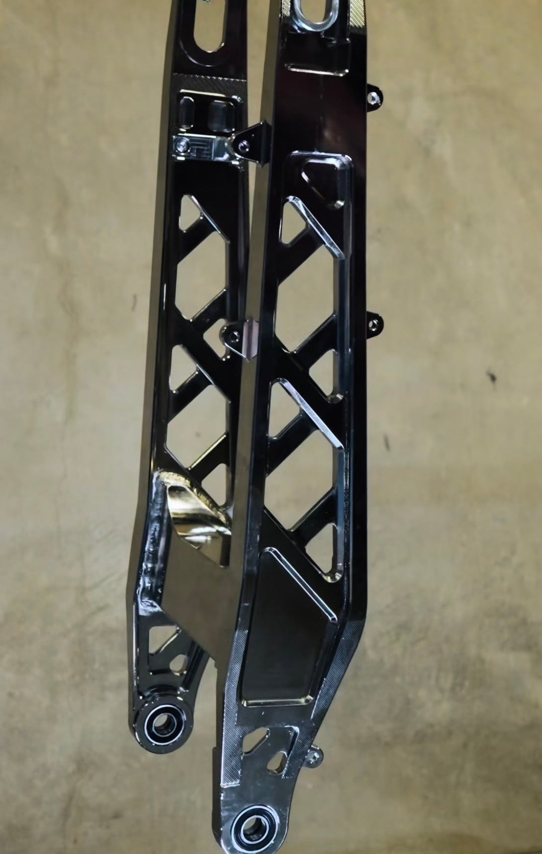 KyVex Billet Swingarm for Surron Ultra Bee — installed detail photo