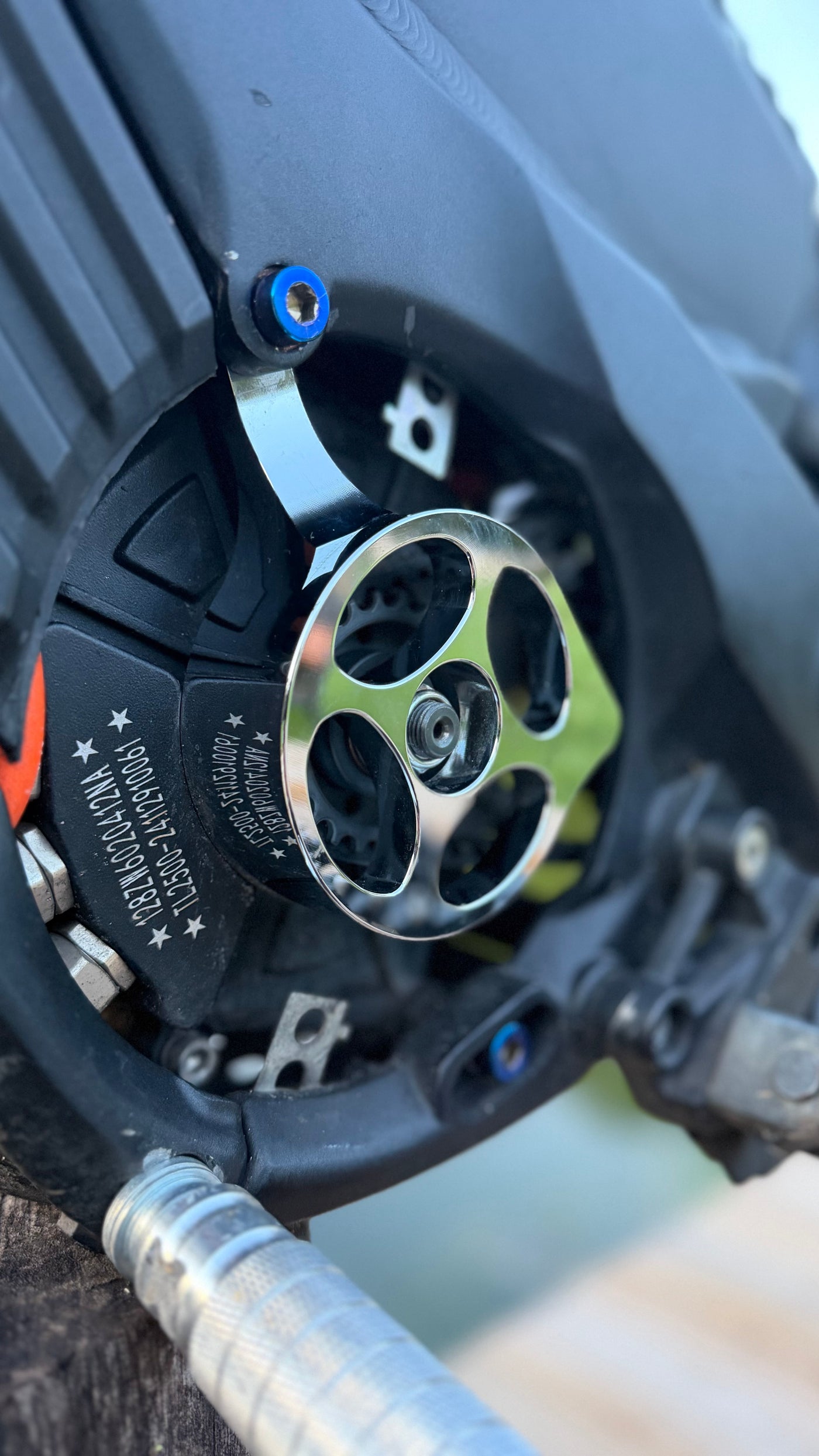 Metal motor cover V1 for Talaria XXX — installed detail on chain drive