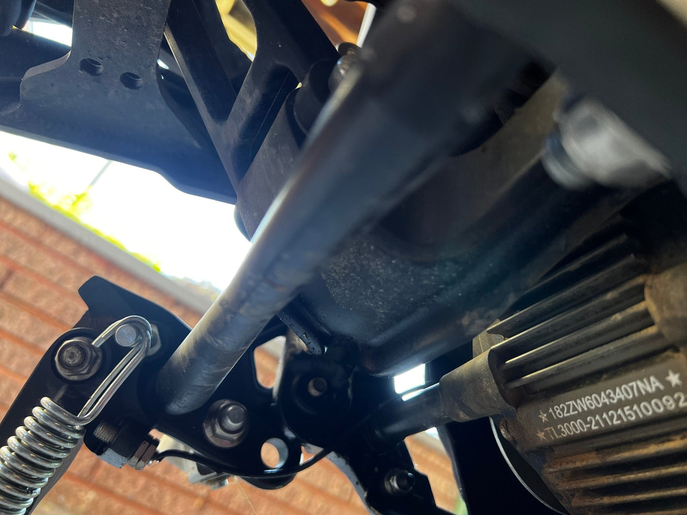 GritShift Talaria Sting footpeg support brace installed on V2 frame