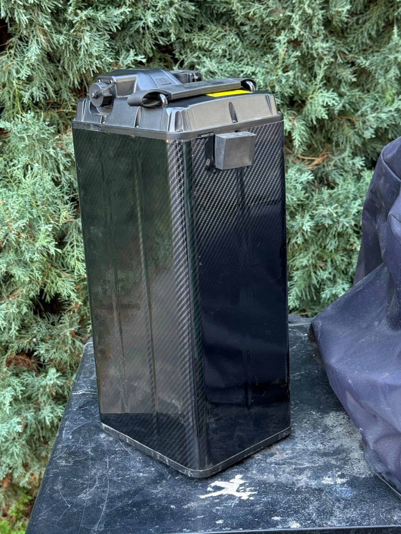 Carbon fiber battery wrap for Surron and Talaria — back corner detail