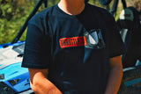 Close-up of the red Throttle Co badge and goggles chest graphic, blue UTV in the background