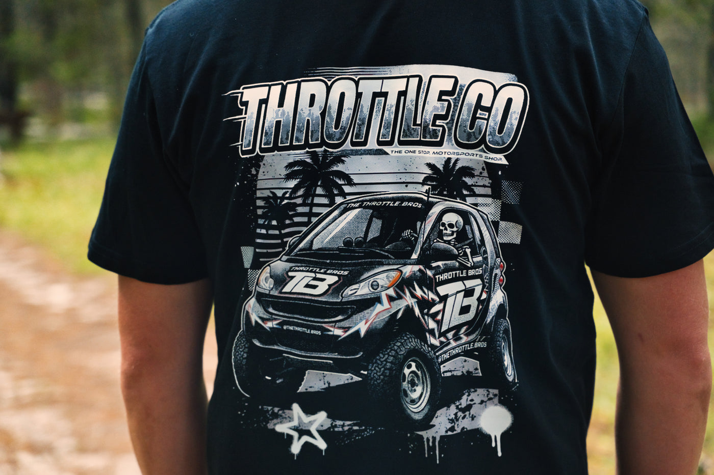 Close-up of the Smart Car back graphic showing the THROTTLE CO logotype, lifted Smart Car in TB race livery and star accent