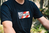 Close-up of the Throttle Bros American flag chest panel on the black tee, showing the logo over stars and stripes