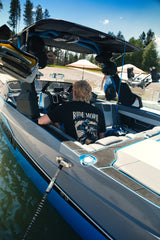 Rider seated in a wake boat wearing the Ride More Bike Tee