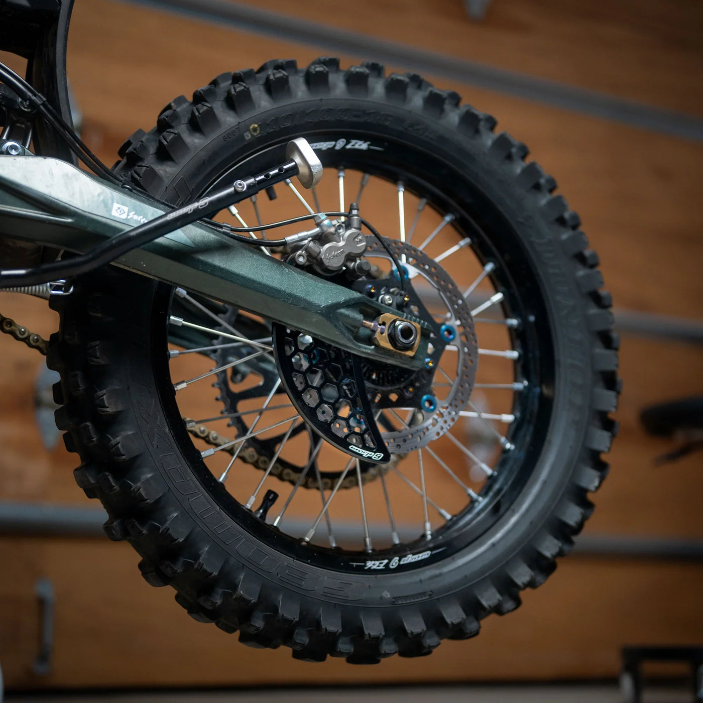 Warp 9 Ultra Bee disc guard — installed on Surron Ultra Bee rear brake protection