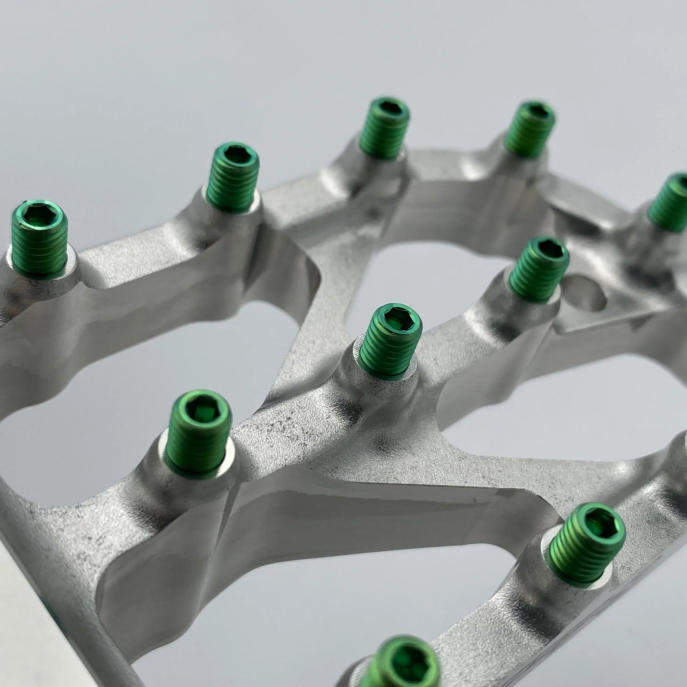 Warp 9 Titanium Elite Peg Screws for Surron — angled view showing screw head geometry