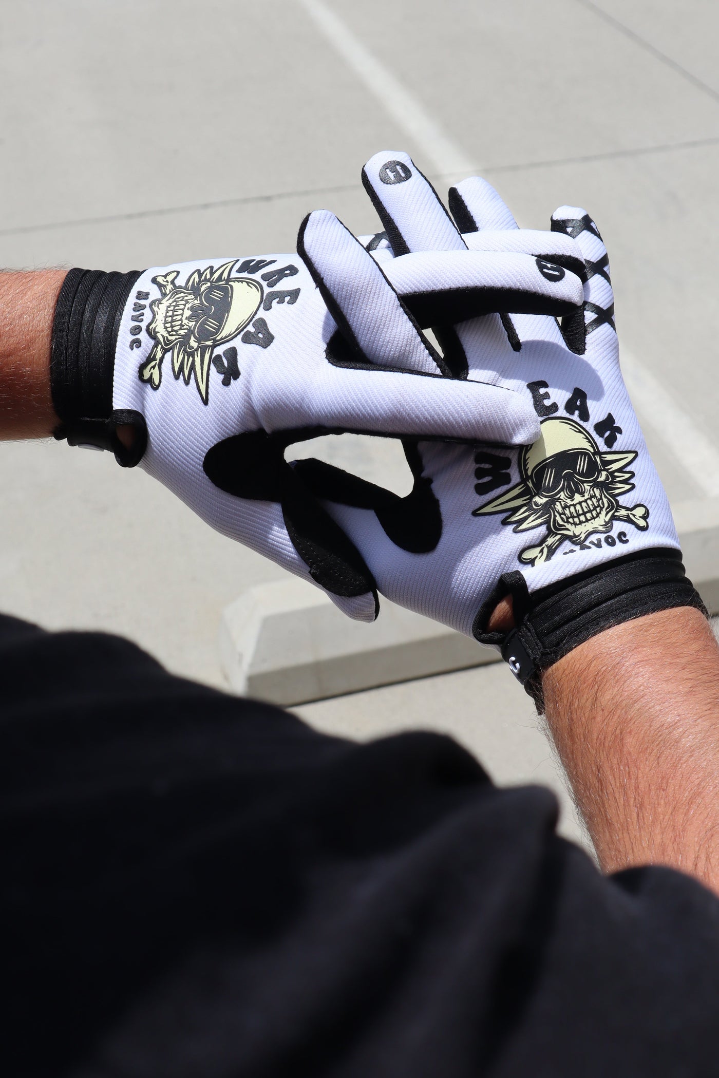 Skull and Crossbones gloves for Surron and Talaria riders — worn on the bike