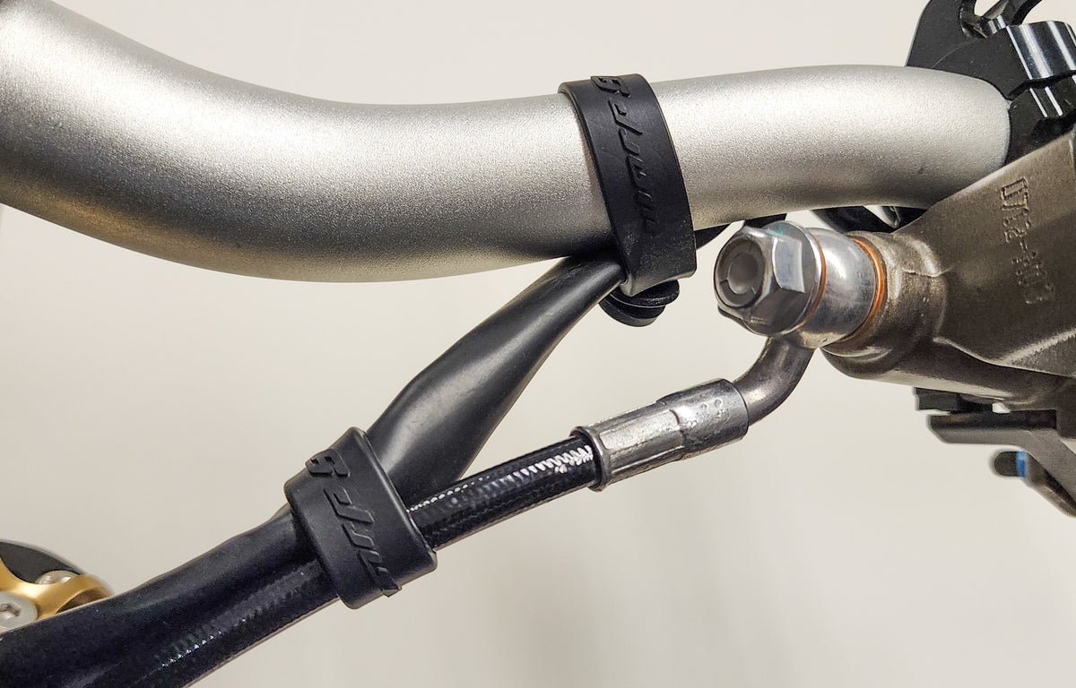 Warp 9 Bar Straps for Surron & Talaria — installed on handlebar