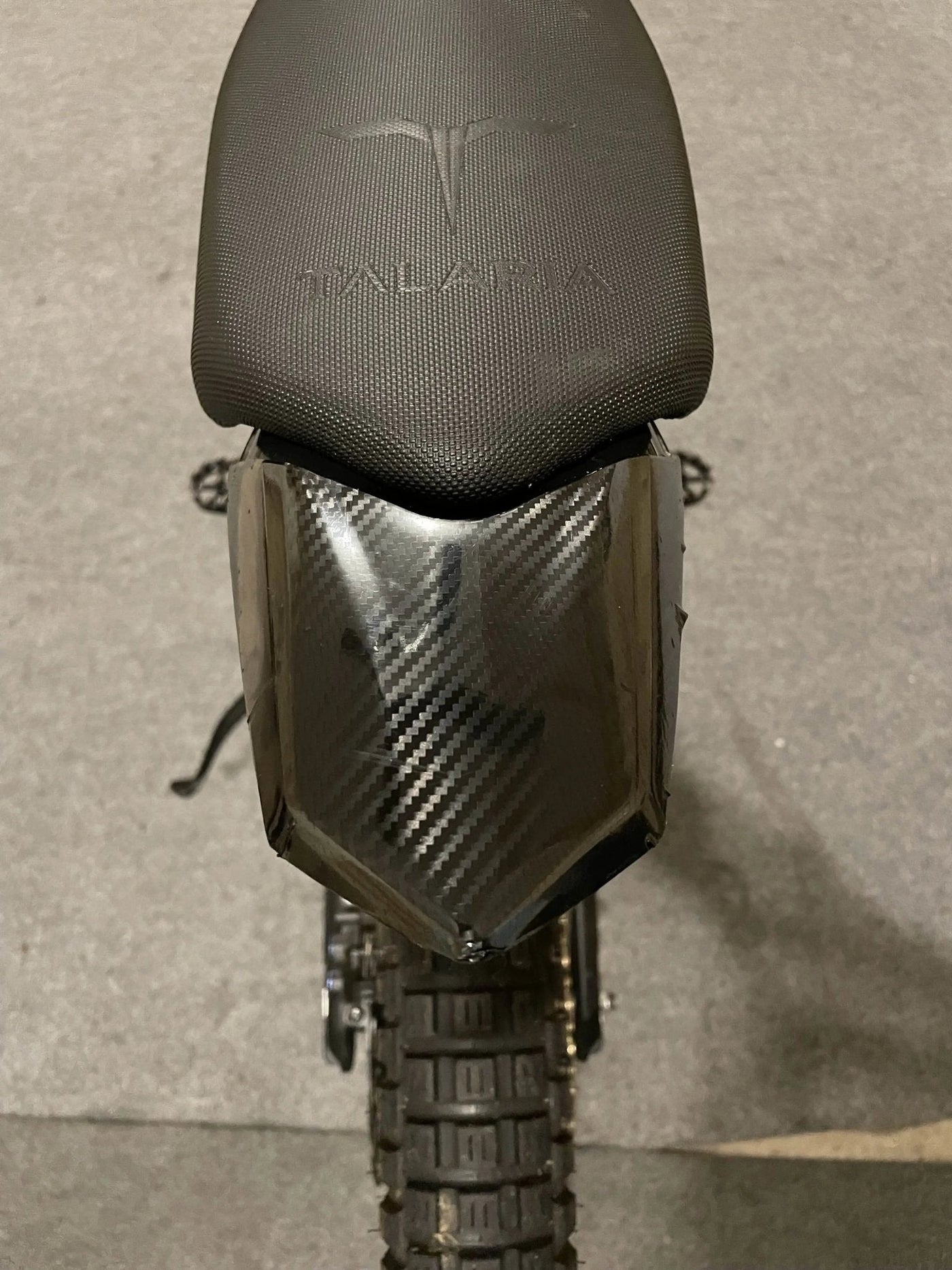 Talaria Sting MX3/MX4 carbon fiber wrap kit — applied on panel