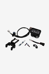Warp 9 V2 headlight kit — LED light, W9 fork clamp bracket, wiring harness with button, titanium bolts, and cable guide
