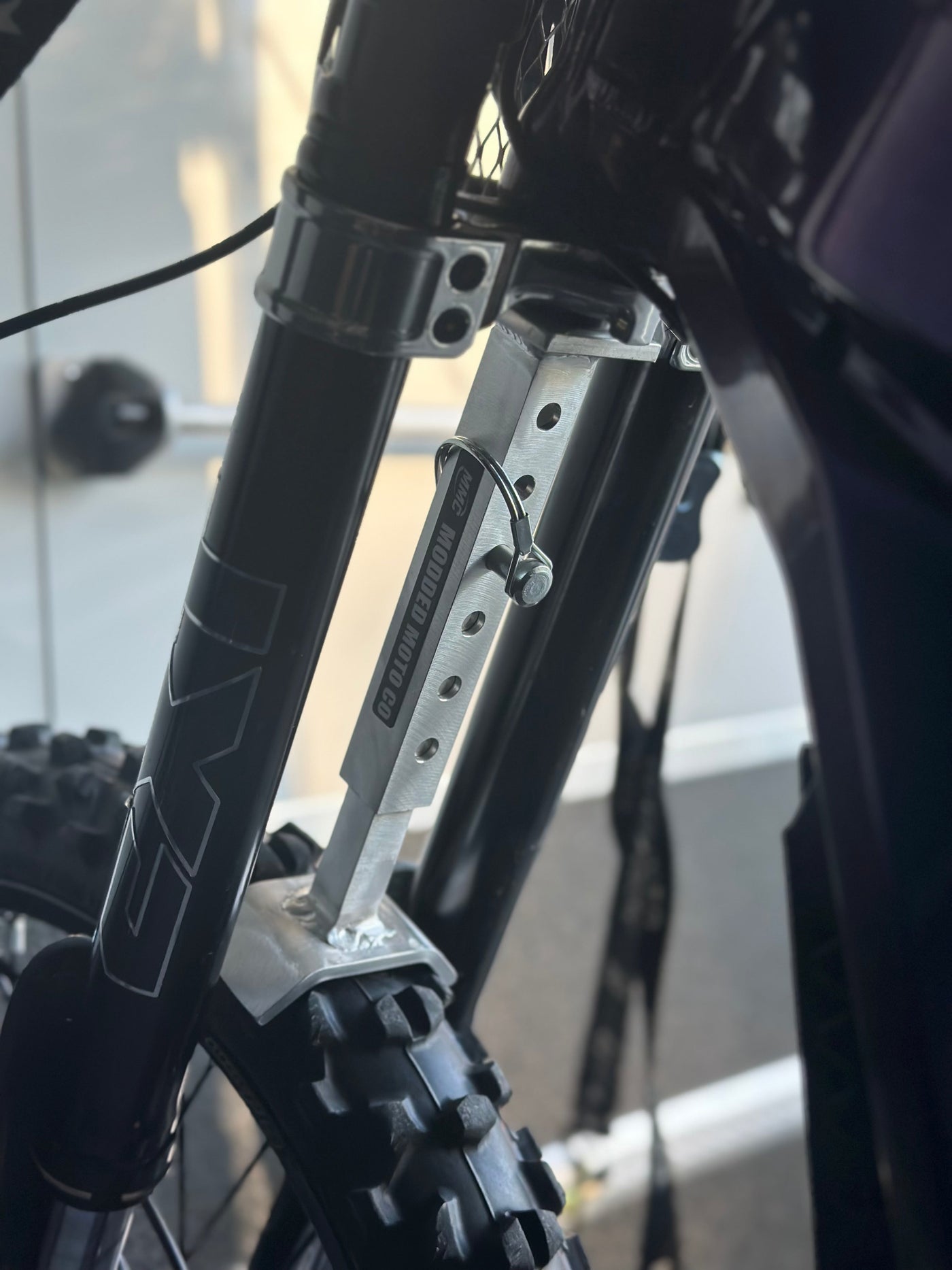Adjustable Fork Saver — installed set on e-moto front fork pair
