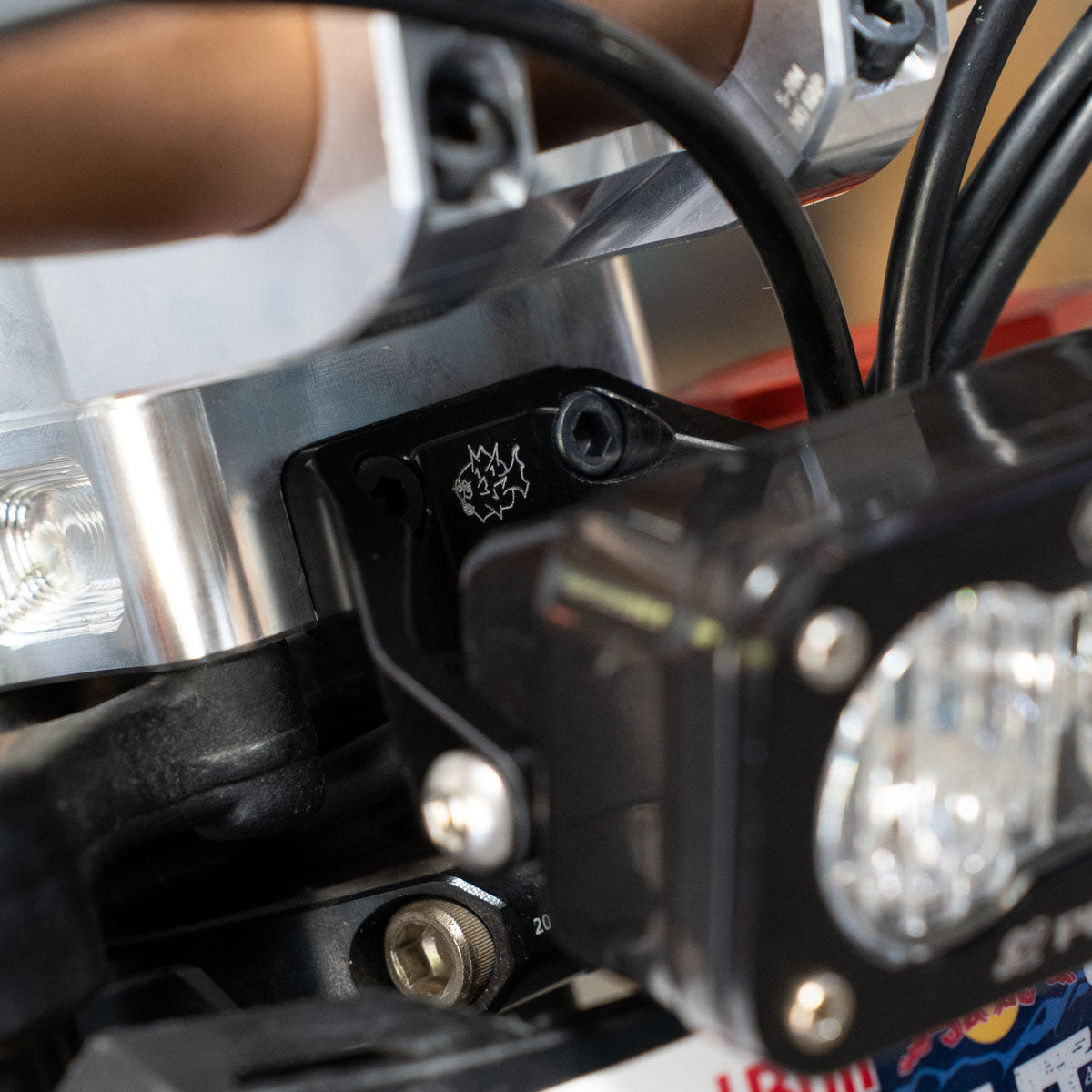 S2 headlight mount for Surron LBX — billet bracket angled view showing hardware detail