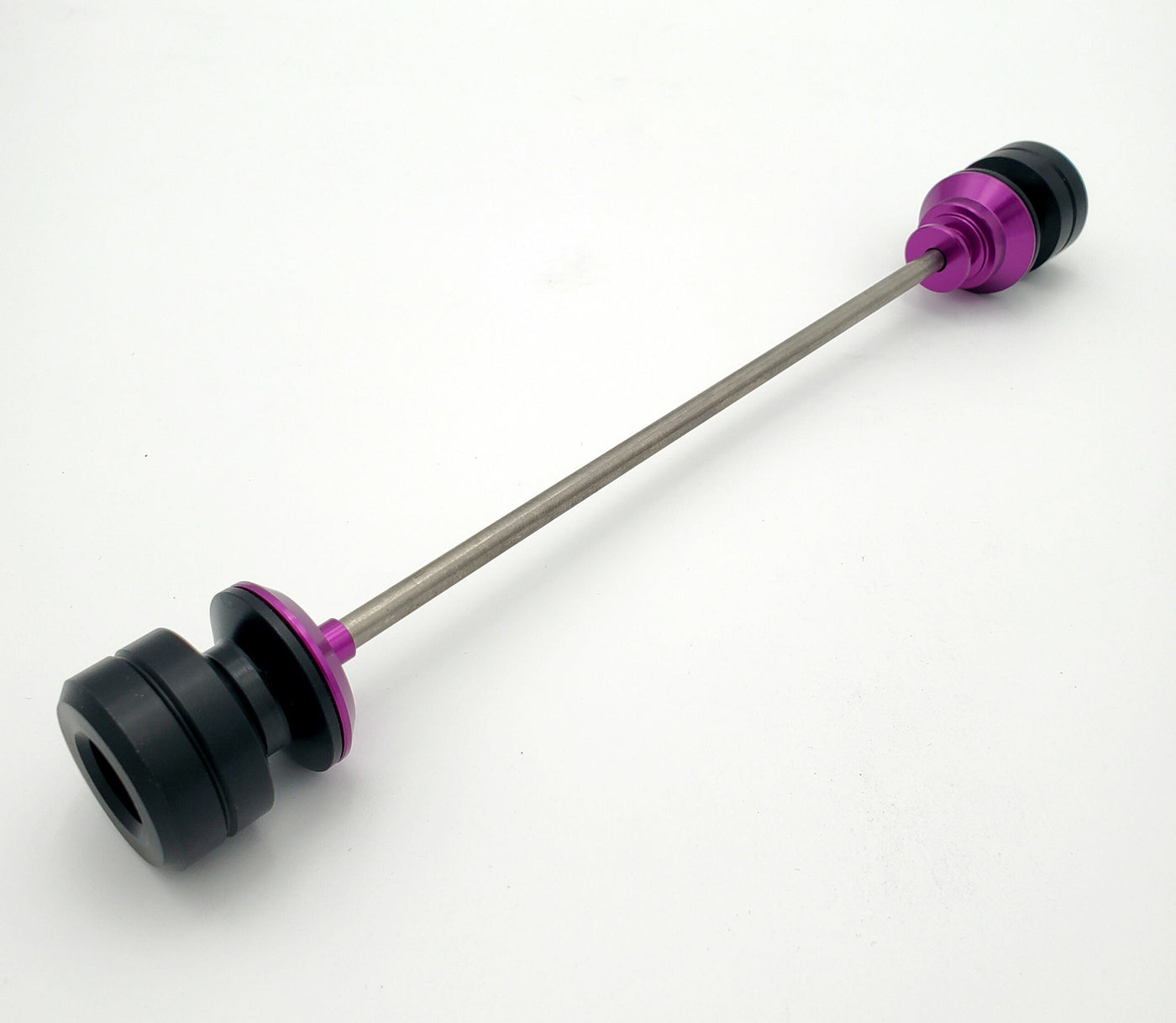 Warp 9 Ultra Bee front supermoto axle slider in purple anodized — CNC machined with captive axle blocks and alignment marks
