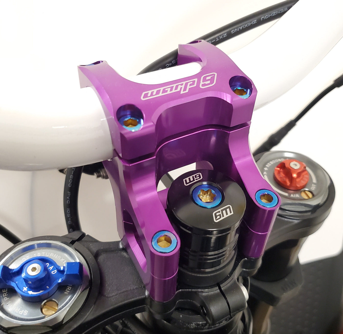 Titanium stem lock bolt installed on Talaria MX4 steering stem — Warp 9