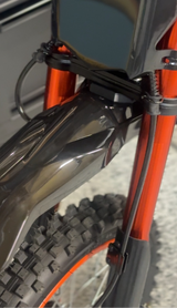 Talaria Front Fender — mounting adapter plate close-up on fork