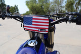 Havoc Bar Sack USA colorway mounted on electric dirt bike handlebar on the trail
