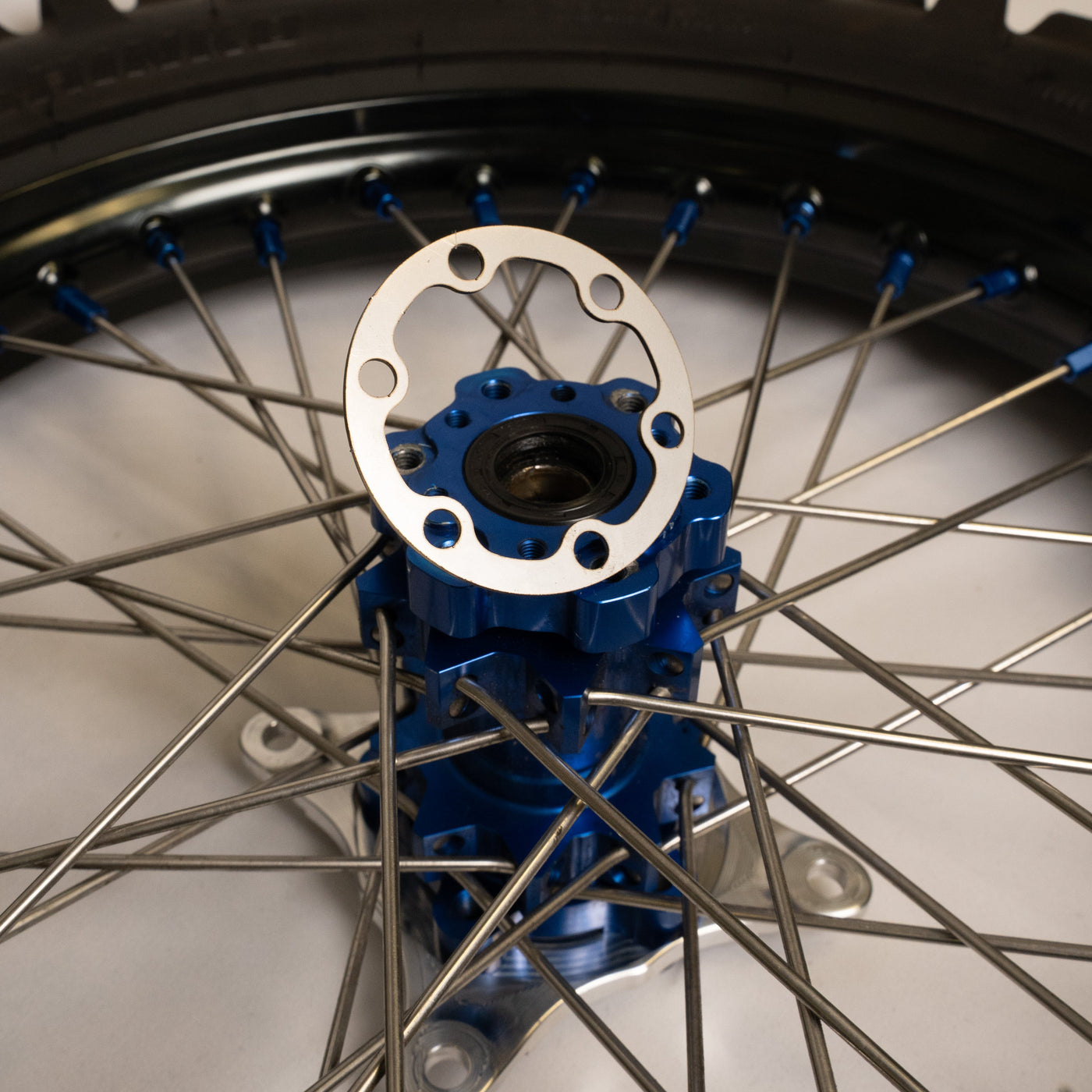 Prickly V3 rotor hub spacer for Surron LBX — installed on rear hub