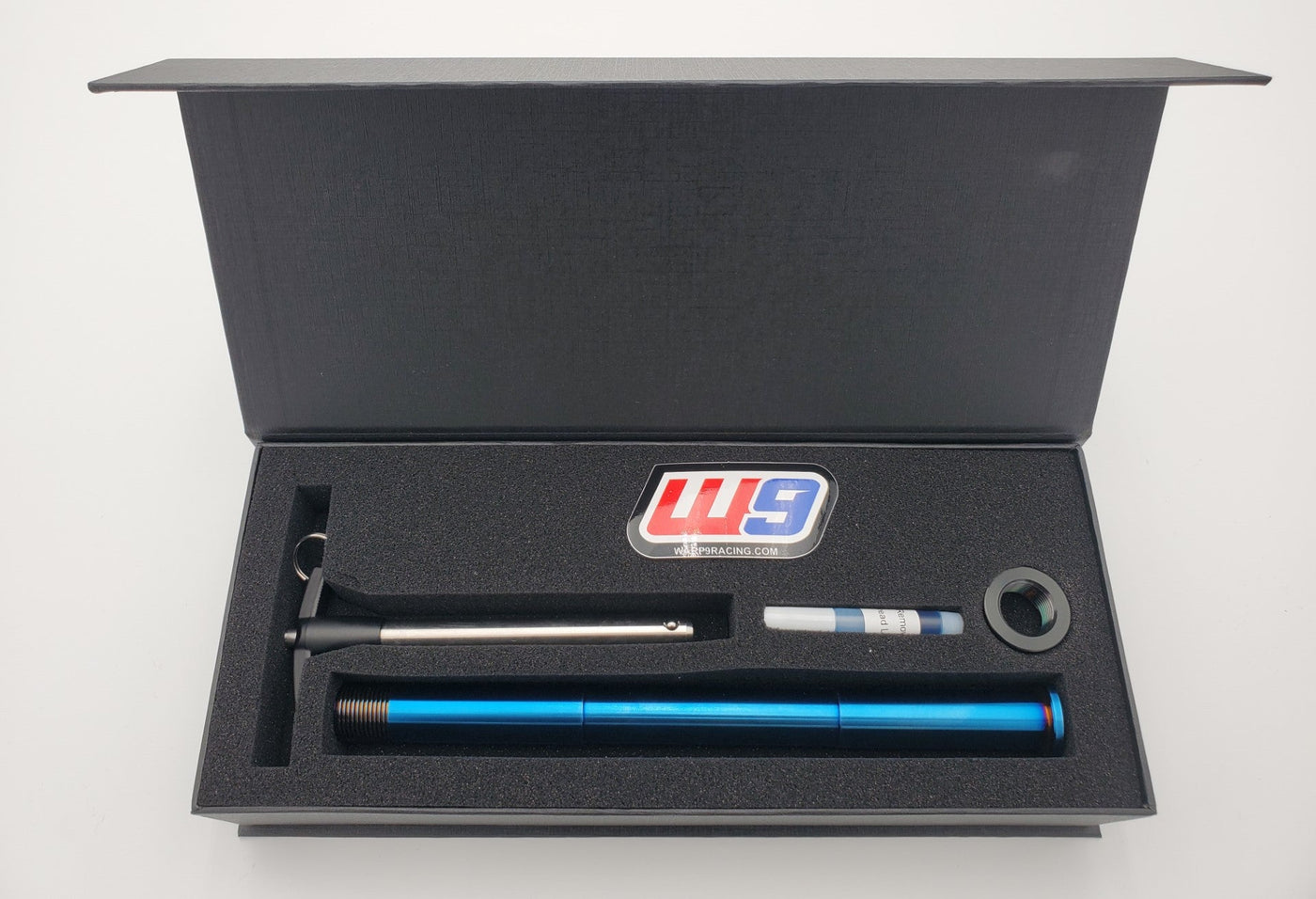Titanium quick-pull rear axle for Surron Ultra Bee — burnt blue