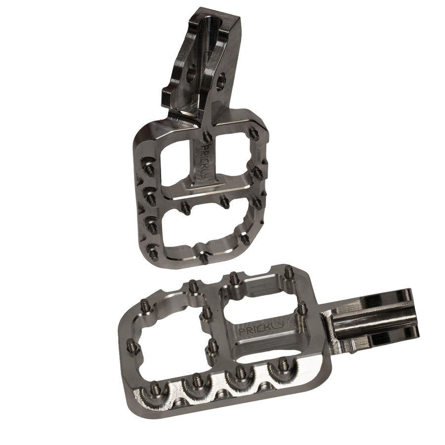 Prickly wide foot pegs for Surron Ultra Bee in raw billet finish